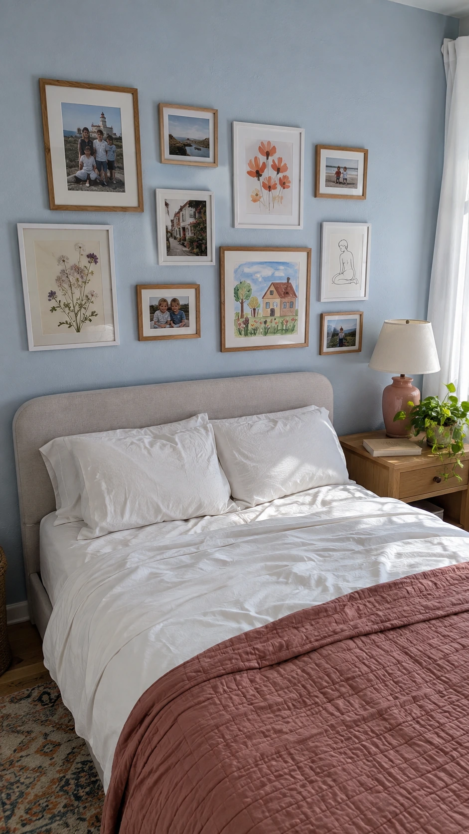 Dreamy Bedroom Ideas: personal gallery wall of family photos, watercolor, pressed flowers, and line art above a powder-blue bed