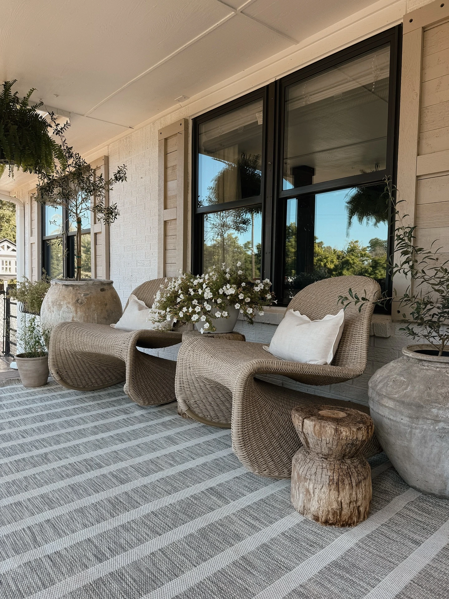 8- Place Round Planters Beside Outdoor Chairs
