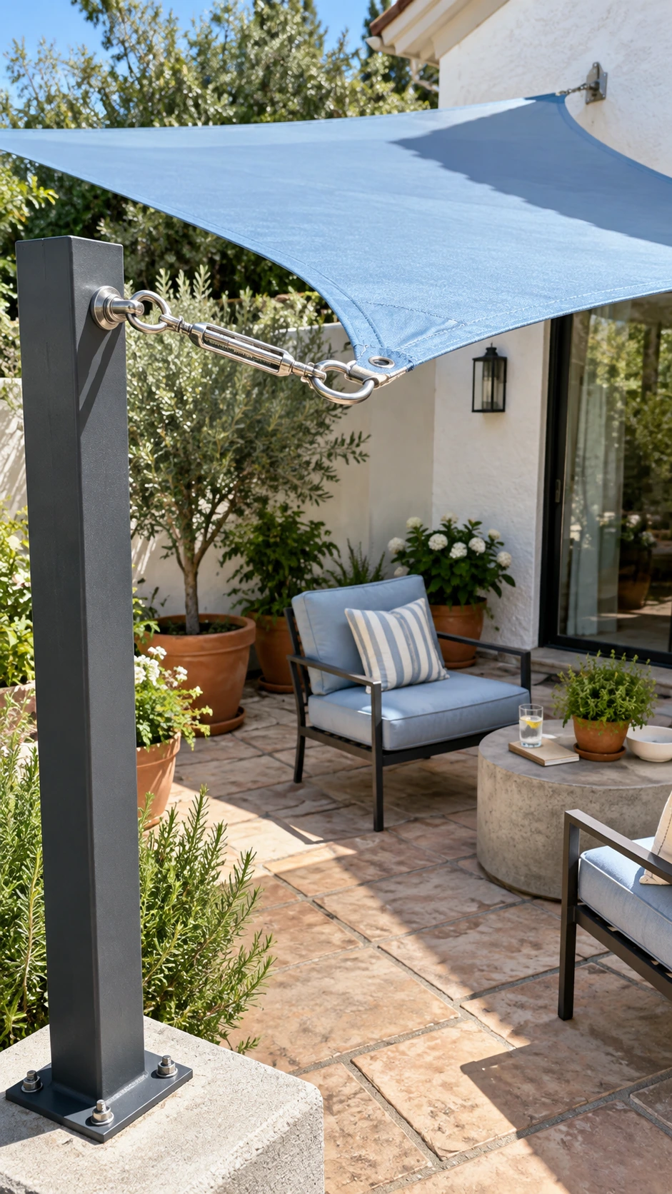 Taut coastal-blue shade sail corner secured with stainless turnbuckle and eye bolt for patio shade ideas over seating