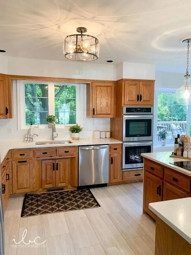 6- Lighten Oak Cabinets With Pale Wood Flooring